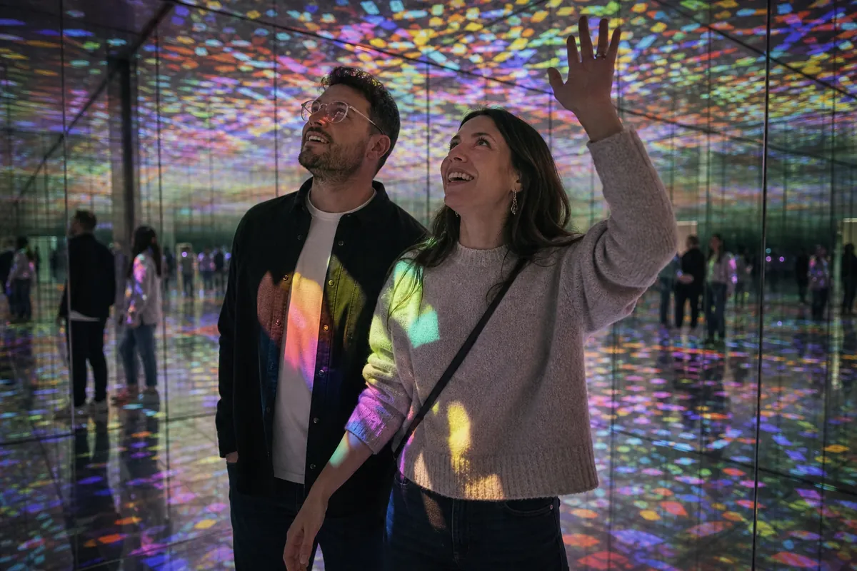 Adult couple exploring a colorful immersive art installation in Portland